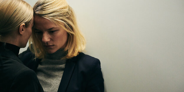 Zwei blonde Frauen lehnen sich mit ihren Köpfen aneinander Zwei blonde Frauen lehnen sich mit ihren Köpfen aneinander