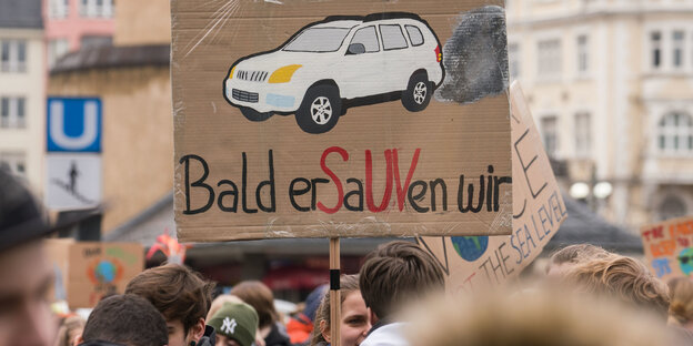 Schülermenge, Plakat mit der Aufschrift "Bald erSaUVen wir" wird hochgehalten Schülermenge, Plakat mit der Aufschrift "Bald erSaUVen wir" wird hochgehalten