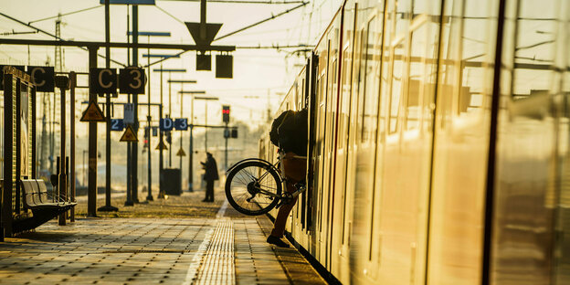 Ein Fahrrad wird in eine S-Bahn geschoben