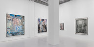 Blick in die neue Ausstellung von Adrian Ghenie in der Galeria Plan B. Vier Gemälde in unterschiedlichen Größen zieren zwei Wände, in der Mitte ist eine raumtragende Säule zu sehen. Auf dem Bild ganz links, das von blauen Linien überzogen ist, beugt sich