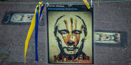 Beschmiertes Plakat von Putin nahe des russischen Konsulats in Frankfurt