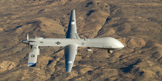 Militärdrohne fliegt über karger Landschaft Militärdrohne fliegt über karger Landschaft